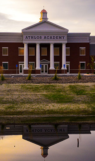 Front of Athlos Academy school at dusk