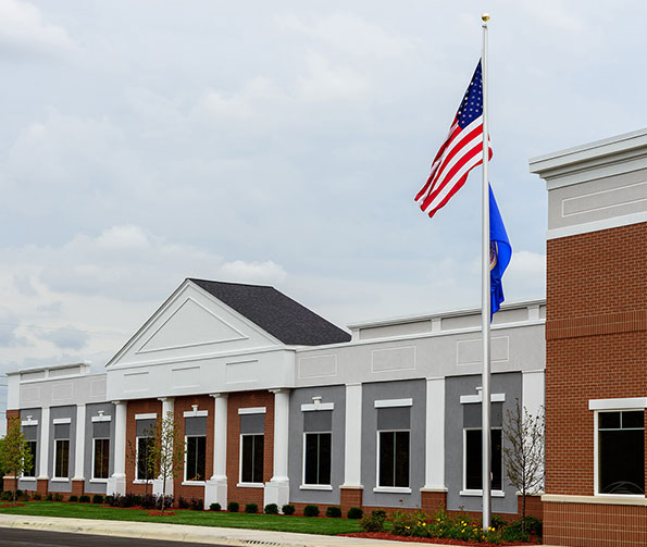Front of Athlos Academy school with U.S. flag